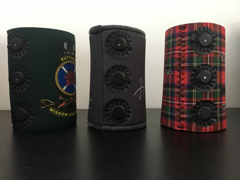 Magnetic stubby holders made in Australia next to a white wall